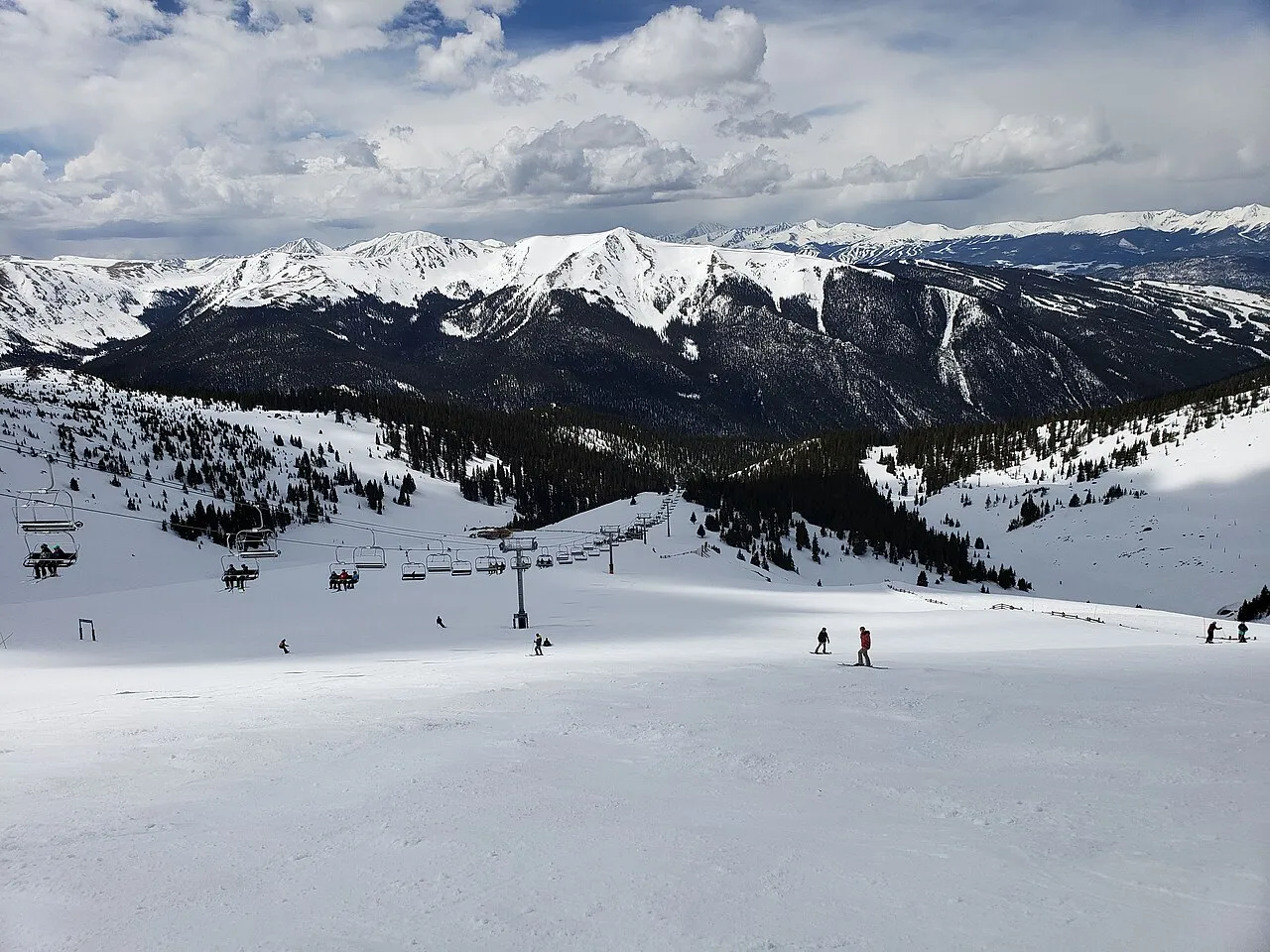 Skiers ski past the Zuma ski lift in the Montezuma Bowl area at Arapahoe Basin Ski Area in Colorado.
