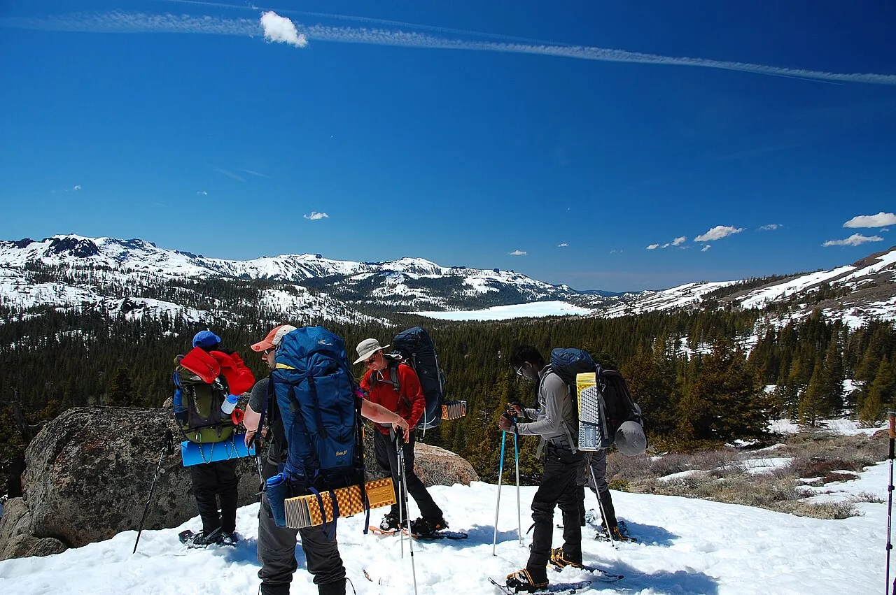 Party snowshoeing in Kirkwood Mountain Resort, facing northeast towards Caples Lake, Alpine County, California.