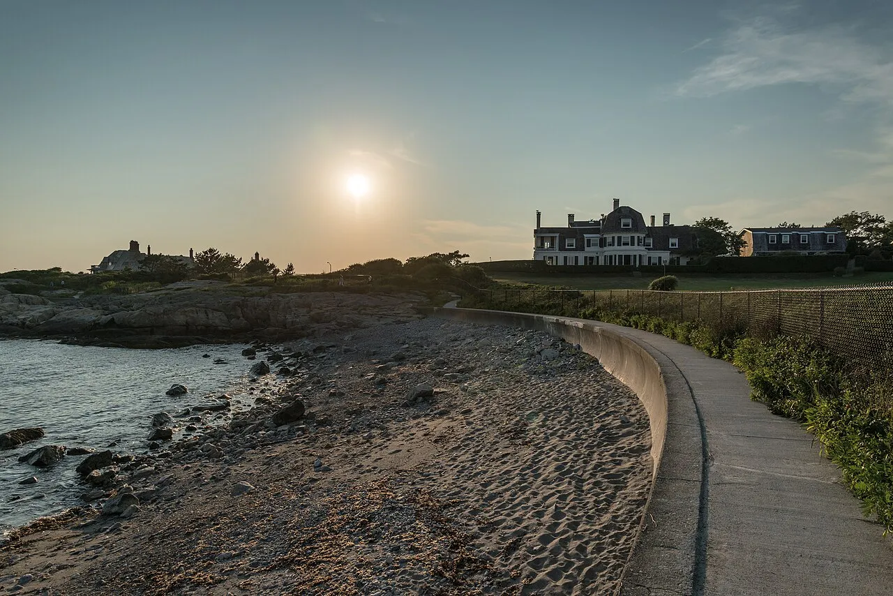 The Cliff Walk path at sunset, mansions on the bluff