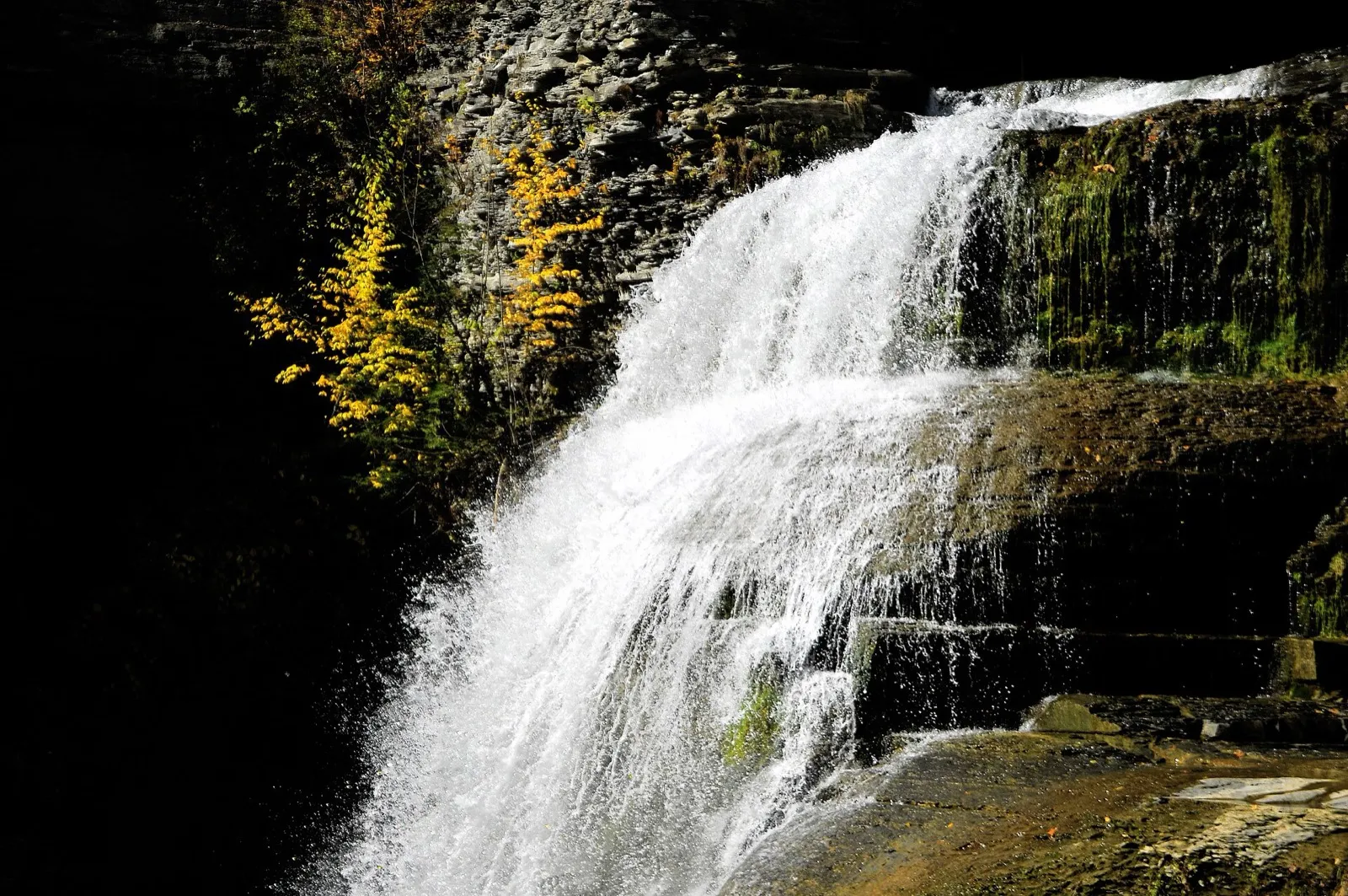 Sunlit waterfall in Enfield Glen