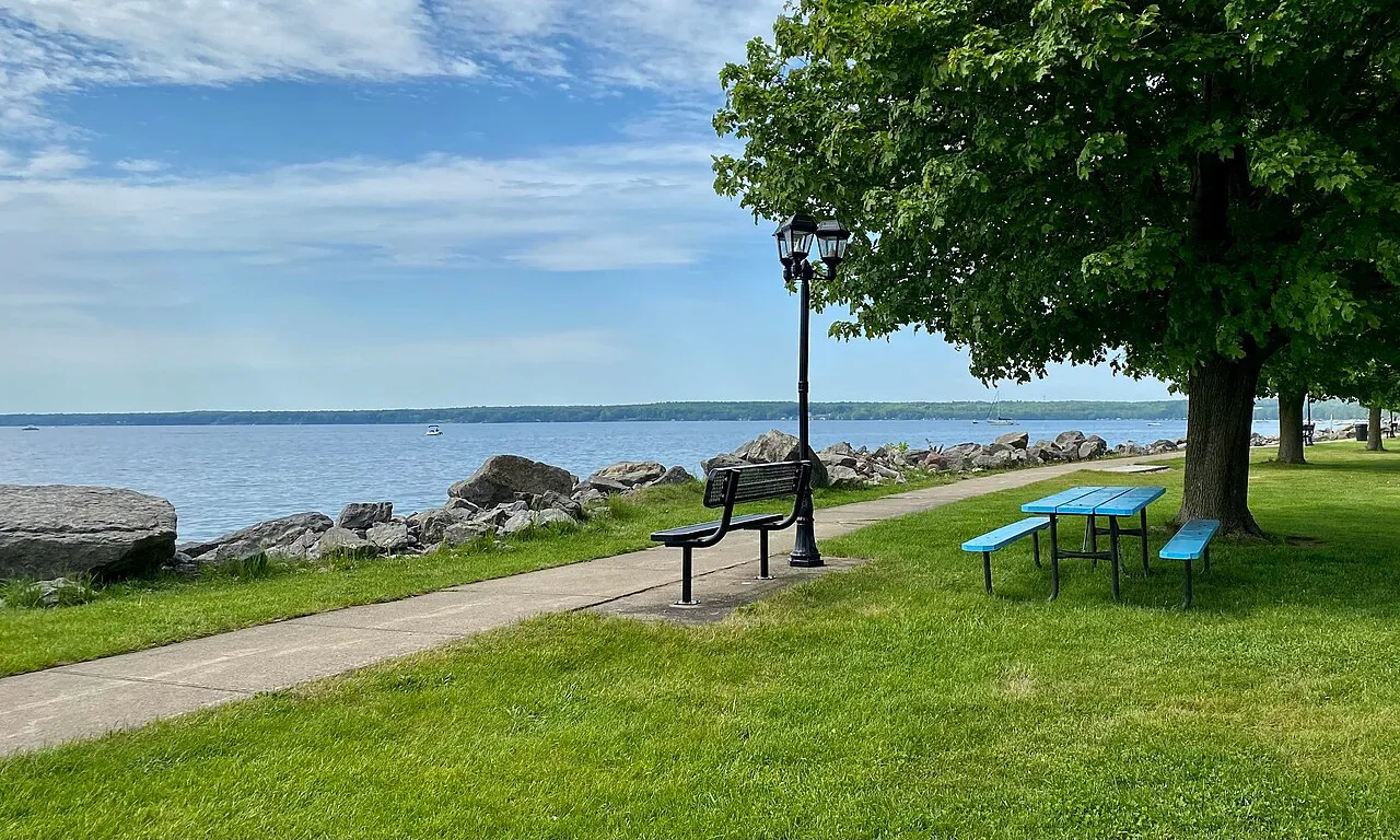 Park benches and picnic tables afford visitors to Sunset Park in Sylvan Beach, New York pleasant vistas over Oneida Lake.