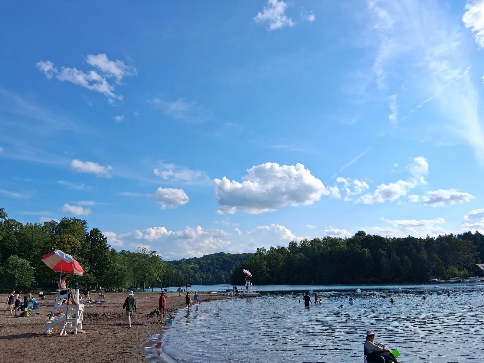 Swimmers at the sandy beach on Green Lake on a summer day