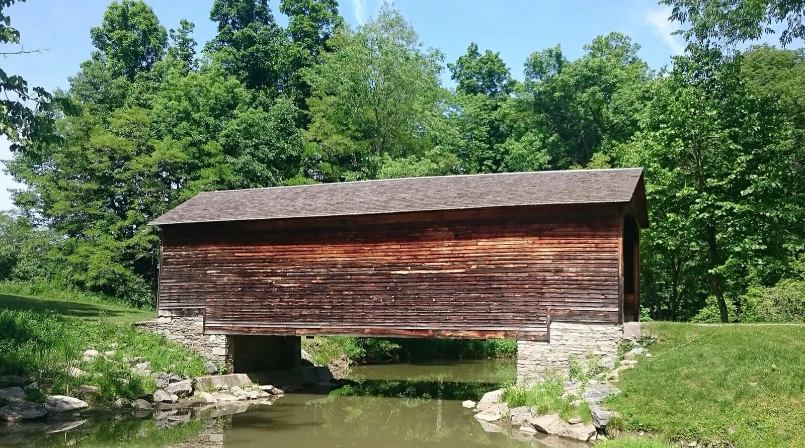 Weathered Hyde Hall Covered Bridge spanning Shadow Brook