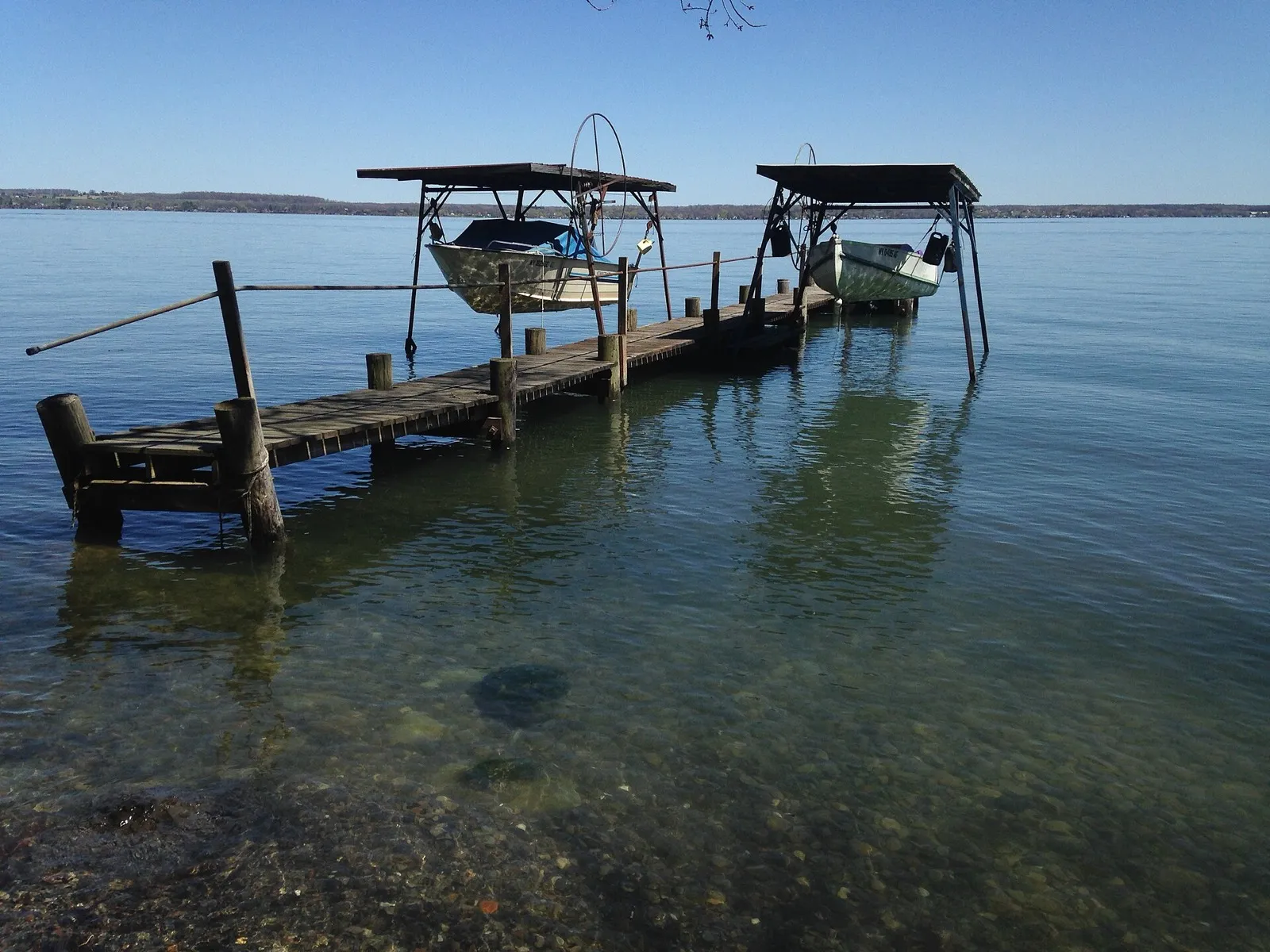 Small boat dock on clear, calm Seneca Lake